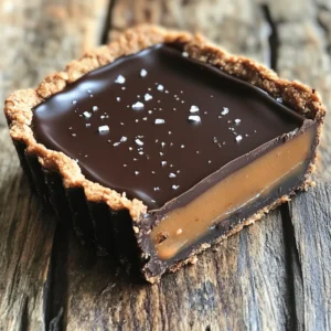 - 1 1/2 cups chocolate cookie crumbs (or graham cracker crumbs) - 1/2 cup unsalted butter, melted - 1 cup medjool dates, pitted - 1/2 cup coconut milk - 1/2 cup creamy almond butter - 1 teaspoon vanilla extract - 1/2 cup maple syrup (or honey) - 1/4 teaspoon sea salt (plus extra for topping) - 1/2 cup dark chocolate chips - 1 tablespoon coconut oil You can change this tart to fit your taste. Here are some ideas: - Use different nut butters like cashew or peanut butter. - Add a pinch of cinnamon or nutmeg for extra warmth. - Top with fresh fruit like berries or banana slices. You will need a few tools to make this tart easy: - A 9-inch tart pan for the crust. - A mixing bowl for the crust and filling. - A blender or food processor for the caramel layer. - A small saucepan for melting chocolate. - A spatula to spread the chocolate topping. - A refrigerator to chill and set your tart. To start, grab a mixing bowl. Combine 1 1/2 cups of chocolate cookie crumbs with 1/2 cup of melted unsalted butter. Mix well until the crumbs are fully coated. Now, take a 9-inch tart pan and press this mixture into the bottom and sides. Make sure it’s even and firm. Once done, place the tart crust in the refrigerator. Let it chill while you make the filling. Next, it’s time to create the caramel layer. In a blender or food processor, add 1 cup of pitted medjool dates, 1/2 cup of coconut milk, and 1/2 cup of creamy almond butter. Don’t forget the 1 teaspoon of vanilla extract, 1/2 cup of maple syrup, and 1/4 teaspoon of sea salt. Blend everything until it’s smooth and creamy. If the mixture is too thick, add a splash of water to make it pourable. Once your crust is set and the caramel is ready, pour the caramel mixture over the chilled crust. Spread it evenly with a spatula. Gently tap the pan on the counter to remove any air bubbles. Place the tart back in the refrigerator for at least 1 hour. This helps the caramel layer firm up nicely. - Finishing Touches with Chocolate Topping To prepare the chocolate topping, melt 1/2 cup of dark chocolate chips with 1 tablespoon of coconut oil in a small saucepan over low heat. Stir until the mixture is smooth. Remove it from the heat and let it cool for a bit. Once the caramel layer is set, pour the melted chocolate over it. Spread it evenly and sprinkle a pinch of sea salt on top for that perfect salted caramel finish. Return the tart to the fridge for another 30 minutes. This allows the chocolate to set. After that, slice your tart and serve it chilled. Enjoy the delicious layers of flavors! When making a no-bake tart, avoid overmixing the crust. If you mix too much, the crust can be tough instead of crumbly. Also, don’t skip chilling the tart. This step helps the layers set properly. If you don’t chill, the tart may fall apart when you slice it. To get the best flavor, use fresh medjool dates. They should be soft and sweet. For a creamier filling, blend the ingredients long enough to remove all lumps. Adding a splash of water can help achieve a smooth texture. If you want a deeper flavor, try using dark chocolate with a higher cocoa content. Presentation matters! After slicing the tart, drizzle extra melted chocolate on top. This will make it look more delicious. A light sprinkle of sea salt adds a nice touch too. You can also serve slices with fresh berries or a dollop of whipped coconut cream for a pop of color and taste. {{image_2}} You can switch almond butter for other nut butters. Try creamy peanut butter for a rich taste. Sunflower seed butter works well too, especially for nut-free needs. Each option adds a unique flavor to the tart. Experiment and find your favorite! Want to change the flavor? Add a pinch of sea salt for extra taste. You can also try cinnamon or vanilla for warmth. A splash of espresso can deepen the chocolate flavor. Play with spices to match your mood! To make the tart gluten-free, use gluten-free cookie crumbs. Almond butter is already vegan, so you're set there! Use maple syrup instead of honey for a fully vegan treat. These swaps keep the tart delicious and accessible for many diets. To store your No-Bake Salted Caramel Chocolate Tart, wrap it tightly in plastic wrap. You can also use an airtight container. This helps keep the tart fresh and prevents it from drying out. Store it in the fridge for up to five days. The flavors will blend and improve over time! If you want to keep the tart longer, freezing is great. First, slice the tart into pieces. Wrap each slice in plastic wrap, then place them in a freezer bag. This keeps them safe from freezer burn. The tart can last up to three months in the freezer. When you're ready to enjoy it, thaw in the fridge overnight. For the best taste, serve the tart chilled. Remove it from the fridge shortly before serving. This makes it easier to slice. You can add a drizzle of melted chocolate and a sprinkle of sea salt on top. Fresh berries or whipped coconut cream on the side can also add a nice touch. Enjoy this sweet treat! The tart can last up to five days in the fridge. Keep it covered to stay fresh. The flavors may blend and deepen over time, making each bite even better. Yes, you can use many types of chocolate. Milk chocolate gives a sweeter taste, while dark chocolate adds richness. White chocolate can add a creamy layer, too. Choose based on your taste preference. If you don’t have medjool dates, try using dried figs or prunes. Both give a similar sweetness and texture. You can also use maple syrup or agave nectar, but adjust the liquid in the recipe. To make the tart gluten-free, use gluten-free cookie crumbs. Almond flour works well, too. Just ensure all other ingredients are gluten-free. This way, everyone can enjoy this tasty treat! This article offered a detailed guide on making a delicious tart. We covered the main ingredients, step-by-step instructions, and helpful tips. You learned about variations to suit your tastes and how to store leftovers properly. Now you have the tools to create a fantastic tart. Experiment with flavors and enjoy the process. Remember, practice makes perfect, so don’t stress if it doesn’t turn out right away. Enjoy your baking journey!