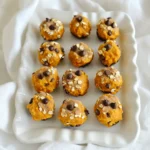 To make these No Bake Pumpkin Peanut Butter Bites, you'll need simple ingredients. Here’s what you should gather: - 1 cup pumpkin puree - 1/2 cup natural peanut butter - 1/4 cup rolled oats - 1/4 cup honey or maple syrup - 1 teaspoon cinnamon - 1/2 teaspoon nutmeg - 1/2 teaspoon vanilla extract - 1/4 cup chocolate chips (dark or milk) - A pinch of salt These ingredients work together to create a tasty treat. The pumpkin puree brings in moisture and flavor. Natural peanut butter adds creaminess and protein. Rolled oats give these bites a nice texture. You can choose honey or maple syrup for sweetness. Cinnamon and nutmeg add warmth and a hint of spice. Vanilla extract enhances the overall taste. Finally, chocolate chips provide a sweet touch that everyone loves. When you combine these ingredients, you create a healthy snack that is easy to make. You can adjust the sweetener to your taste. If you prefer a sweeter bite, add more honey or syrup. If you want less sweetness, reduce the amount. The spices can also be adjusted. If you love cinnamon, add a bit more! Gather these ingredients, and you’re on your way to making a delicious treat. Each one plays a vital role in the final flavor and texture. Enjoy experimenting with your own twists on this recipe! - Mixing the Base Ingredients Start by taking a large bowl. Add 1 cup of pumpkin puree and 1/2 cup of natural peanut butter. Stir them well until they blend together smoothly. This mix is the heart of your bites. - Incorporating Oats and Sweetener Next, add 1/4 cup of rolled oats and 1/4 cup of honey or maple syrup. These ingredients add texture and sweetness. Stir until everything is fully combined. - Adding Spices and Flavorings Now, sprinkle in 1 teaspoon of cinnamon, 1/2 teaspoon of nutmeg, and 1/2 teaspoon of vanilla extract. These spices give your bites a warm, cozy flavor. Don’t forget a pinch of salt to balance the sweetness. Mix again to blend these flavors well. - Folding in Chocolate Chips Finally, gently fold in 1/4 cup of chocolate chips. This adds a sweet surprise to each bite. Be careful not to crush the chips as you mix. - Forming the Balls After mixing, it’s time to shape the mixture. Use your hands to scoop out small amounts, about 1 inch in diameter. Roll them into balls. This is a fun and hands-on part of the process. - Arranging on Baking Sheet Place each ball on a parchment-lined baking sheet. Make sure to leave some space between them. This helps them chill evenly later. - Refrigeration Process Once all the bites are shaped, put the baking sheet in the fridge. This helps them firm up, making them easier to eat. - Timing for Firming Up Let the bites chill for about 30 minutes. This time allows them to set properly. After chilling, they are ready to enjoy. Store any leftovers in an airtight container in the fridge for freshness. Adjusting Sweetness You can change the sweetness by using more or less honey or maple syrup. Start with 1/4 cup, then taste. If you like it sweeter, add a little more. Remember, pumpkin has its own natural sweetness. Ensuring Proper Mixing Mix the pumpkin puree and peanut butter well. This helps the flavors blend. Use a sturdy spoon or spatula. Make sure no lumps remain. When you add oats and spices, mix until everything is even. This will give you a great texture. Pairing with Dips or Toppings These bites are tasty on their own, but you can add dips. Try yogurt or a chocolate sauce for extra flavor. You can also sprinkle some crushed nuts on top for crunch. Ideas for Serving at Events These bites are fun to serve at parties. Place them on a colorful platter. You can also use small cups or skewers for easy eating. They make a great treat for kids and adults alike. Nutritional Value of Pumpkin Pumpkin is low in calories and high in vitamins. It has a lot of vitamin A, which is good for your eyes. Pumpkin also has fiber, which helps with digestion. Benefits of Peanut Butter Peanut butter is packed with protein. It keeps you full and gives you energy. It also contains healthy fats that are good for your heart. Choose natural peanut butter for the best health benefits. {{image_2}} You can make your No Bake Pumpkin Peanut Butter Bites even more fun! Try adding different nuts or seeds. Chopped almonds or walnuts give a nice crunch. Sunflower seeds add a nutty flavor and boost nutrients. Both choices keep your bites tasty and healthy. You can also spice things up by incorporating other spices. Besides cinnamon and nutmeg, try ginger or allspice. These spices add warmth and depth. You can mix and match based on your taste buds. You can easily adapt this recipe to fit your diet. For vegan options, use maple syrup instead of honey. Also, choose a vegan chocolate brand. This way, everyone can enjoy these bites without worry. If you need gluten-free alternatives, use certified gluten-free oats. They are just as delicious and safe for those with gluten sensitivities. This recipe remains tasty and friendly for all diets. Add some fun to your bites with dried fruit. Raisins, cranberries, or chopped dates blend well with pumpkin and peanut butter. They add sweetness and chewiness to your bites. You can also use different types of chocolate. Dark chocolate chips bring a rich taste. Milk chocolate chips offer sweetness, while white chocolate can add a creamy twist. The choices are endless, so get creative! To keep your No Bake Pumpkin Peanut Butter Bites fresh, store them in an airtight container. This helps prevent them from drying out and keeps flavors locked in. You can store them in the fridge for up to a week. If you want to enjoy them later, freezing is a great option. To freeze these bites, first place them on a baking sheet in a single layer. Freeze them for about an hour. Once they are firm, transfer them to a freezer-safe bag or container. This method helps keep their shape. When you’re ready to eat, just take out the desired amount and thaw them in the fridge for a few hours. Watch for signs of spoilage, like an off smell or discoloration. If they look or smell strange, it’s best to toss them. To keep your bites fresh, store them away from heat and direct sunlight. Enjoy them while they’re at their best! Yes, you can use other nut butters. Almond butter works well and has a nice flavor. Cashew butter is also a great choice if you want something mild. Sunflower seed butter is a good option for nut-free diets. Just keep in mind that each nut butter has a unique taste. If you need a pumpkin substitute, try using sweet potato puree. It gives a similar sweetness and texture. You can also use butternut squash puree as a good alternative. Both options keep the bites delicious and help you stick to the recipe's spirit. These bites can stay fresh in the fridge for about one week. Make sure to store them in an airtight container. This keeps them from drying out and helps keep the flavors intact. For longer storage, you can freeze them, which I’ll explain later. Absolutely! You can skip the chocolate chips if you want. Try adding chopped nuts or dried fruit instead for a tasty twist. You can also mix in some seeds for a crunch. This way, you keep the bites fun and add your own flair! We covered how to make delicious pumpkin peanut butter bites using simple ingredients. From mixing the base to shaping the bites, each step is easy to follow. I shared tips for perfect texture, serving ideas, and health benefits. You can even customize these bites to fit your dietary needs. Try these recipes, and you’ll enjoy tasty snacks that are good for you. With proper storage, they can last a while too. Remember, your imagination is the only limit to these bites! Enjoy your healthy treats.