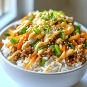 - 1 lb ground turkey - 2 cups cooked jasmine rice - 1 cup green bell pepper, diced - 1 cup carrot, shredded - 1/2 cup green onions, sliced For Bang Bang Ground Turkey Rice Bowls, I start with ground turkey. It’s lean and full of flavor. I use jasmine rice for a perfect base. The rice is fluffy and fragrant. Diced green bell pepper adds crunch and color. Shredded carrot brings sweetness and nutrition. Sliced green onions give a fresh bite. - 1/4 cup mayonnaise - 3 tablespoons sweet chili sauce - 1 tablespoon soy sauce - 1 tablespoon sesame oil - 1 teaspoon lime juice Next, I make the sauce. Mayonnaise adds creaminess and helps bind flavors. Sweet chili sauce gives a nice kick and sweetness. Soy sauce adds umami and depth. Sesame oil brings a nutty flavor. A splash of lime juice brightens everything up. - Salt and pepper - Optional: sesame seeds and cilantro for garnish Finally, I season with salt and pepper. These simple spices enhance the dish. For garnishes, I suggest sesame seeds and fresh cilantro. They add texture and a burst of flavor. {{ingredient_image_1}} First, we need to preheat the skillet. Set your heat to medium and add sesame oil. Let the oil heat for a minute. Then, add the ground turkey. Cook it for about 5 to 7 minutes. Use a spatula to break it apart. Cook until it turns brown. This step gives the turkey a nice texture and flavor. Now, add ginger and garlic to the skillet. Stir these in for 1 to 2 minutes. This will make your kitchen smell amazing. Ginger adds warmth, while garlic brings depth. These flavors will enhance the dish. Next, it’s time to cook the veggies. Add the diced green bell pepper and shredded carrot. Stir these into the skillet. Cook for another 2 to 3 minutes. You want them to soften but still have some crunch. Mixing the veggies with the turkey adds color and nutrition. In a small bowl, combine the sauce ingredients. Mix together mayonnaise, sweet chili sauce, soy sauce, and lime juice. Stir until smooth. This sauce ties all the flavors together. It gives the dish a creamy, tangy taste. To serve, scoop some jasmine rice into a bowl. Top it with the bang bang ground turkey mixture. This is where the magic happens! Garnish with sliced green onions and sesame seeds. You can also add fresh cilantro for extra flavor. Enjoy your meal! To ensure your turkey is cooked thoroughly, use a meat thermometer. The turkey should reach an internal temperature of 165°F. If you don’t have a thermometer, look for no pink in the meat. Break it apart as it cooks. This helps it brown evenly. For the sauce, the right consistency is key. Mix the mayonnaise, sweet chili sauce, soy sauce, and lime juice well. If the sauce is too thick, add a bit of water or more lime juice. This helps it coat the turkey perfectly. To add more flavor, consider using garlic powder or onion powder. These spices boost the taste without overpowering the dish. You can also add a pinch of crushed red pepper for a little heat. Adjusting spice levels is easy. If you like more heat, add sriracha or chili flakes. Start with a small amount and taste as you go. This way, you control the spice. Pair your rice bowls with a fresh side salad. A simple mix of greens with a light dressing works great. Also, consider serving with steamed broccoli or snap peas for a crunchy contrast. For drinks, iced green tea or a light white wine pairs well. A fruity drink can also complement the sweet chili sauce. Choose what you enjoy most! Pro Tips Use Lean Ground Turkey: Opt for lean ground turkey to reduce fat content while keeping your dish flavorful and healthy. Customize Your Veggies: Feel free to swap in other vegetables like zucchini or broccoli for added nutrition and flavor. Make It Spicy: Add a dash of sriracha or red pepper flakes to the sauce if you enjoy a little heat in your dishes. Batch Cooking: Double the recipe and store leftovers in the fridge for quick, healthy meals throughout the week. {{image_2}} You can switch ground turkey for other proteins. Chicken is a great choice. For beef lovers, use ground beef instead. If you prefer plant-based options, tofu works well. Just make sure to adjust cooking times. Chicken cooks fast, while beef takes a bit longer. Tofu needs only a short sauté to warm up and absorb flavors. Feel free to mix in different veggies. Broccoli, snap peas, or zucchini add nice crunch. You can also use spinach for a leafy twist. If you have a veggie you love, toss it in! This dish fits many diets. If you need it vegan, skip the mayo and use a plant-based alternative. You can change the sauce to fit your taste. Add more sweet chili sauce for extra sweetness. If you like heat, sprinkle in some red pepper flakes. To make it milder, reduce the chili sauce. For a dairy-free option, use coconut cream in place of mayo. This keeps the dish creamy and rich without dairy. To keep your Bang Bang Ground Turkey Rice Bowls fresh, follow these tips: - Cool down: Let the dish cool to room temperature before storing. - Containers: Use airtight containers to prevent moisture loss. Glass or plastic containers work well. - Labeling: Mark the date on each container for easy tracking. When it's time to enjoy your leftovers, here’s how to reheat them: - Microwave method: Place a bowl in the microwave. Heat on medium power for 1-2 minutes. Stir halfway through. - Stovetop method: Heat a skillet on medium. Add a splash of water to maintain moisture. Stir the mixture until warm. - Rice texture: Keep an eye on the rice. Add a bit of water if it looks dry. This helps keep it fluffy. If you want to save some for later, freezing is a great option: - Freezing: Portion the dish into airtight containers. Leave some space at the top for expansion. - Thawing: Move the container to the fridge overnight to thaw. - Reheating frozen portions: Use the stovetop or microwave methods mentioned above. Ensure it’s heated all the way through. By following these storage tips, you can enjoy your Bang Bang Ground Turkey Rice Bowls whenever you want! To add heat, you can try a few things. - Add red pepper flakes to the turkey while cooking. - Mix in sriracha with the sauce for an extra kick. - Use spicy chili paste instead of sweet chili sauce. These options will give your dish a nice, warm flavor. Yes, you can easily meal prep this dish. - Cook the turkey and veggies, then let them cool. - Store them in airtight containers in the fridge. - Cook the rice and store it separately. When you’re ready to eat, just reheat everything. This keeps the rice fluffy and the turkey tasty. If you want a different grain, there are great options. - Brown rice adds a nutty flavor and is more filling. - Quinoa is a healthy choice and cooks fast. - Cauliflower rice is low-carb and works well too. These alternatives will fit right in with the bang bang flavors. Look for these signs to know your turkey is done. - The meat should be browned and not pink. - Use a meat thermometer; it should reach 165°F. - The juices should run clear, not pink. These tips ensure your dish is safe and tasty. You have everything you need to make delicious Bang Bang Ground Turkey Rice Bowls. We covered the key ingredients, from ground turkey to fragrant jasmine rice. I showed you step-by-step how to cook the turkey and mix in sweet and savory sauces. Plus, you learned tips for enhancing flavors and serving the dish just right. Remember, you can easily customize this meal based on your tastes. Enjoy creating your own tasty version!