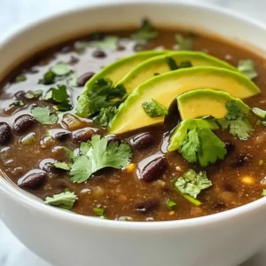 - 2 cans (15 oz each) black beans, drained and rinsed - 1 cup vegetable broth - 1 small onion, diced - 2 cloves garlic, minced - 1 teaspoon ground cumin - 1 teaspoon smoked paprika - &frac12; teaspoon cayenne pepper (adjust to taste) - 1 tablespoon olive oil - Juice of 1 lime - Salt and pepper to taste Black beans are the star of this soup. They give it a rich flavor and creamy texture. You need two cans for this recipe. Rinsing them helps remove extra sodium. Next, the vegetable broth adds depth. It makes the soup warm and comforting without being heavy. I use one cup for balance. Onions and garlic are key for flavor. I dice one small onion and mince two cloves of garlic. Saut&eacute;ing them brings out their sweetness. Spices and seasoning elevate the dish. Ground cumin and smoked paprika add warmth. Cayenne pepper gives a kick, but you can adjust it to your taste. Don't forget salt and pepper to season. - Fresh cilantro - Avocado slices Garnishes make the soup shine. Fresh cilantro adds brightness and color. Avocado slices bring creaminess that contrasts nicely with the soup&rsquo;s texture. Use these for a great finish. {{ingredient_image_1}} First, heat the olive oil in a medium pot over medium heat. Add the diced onion. Saut&eacute; it for about 3-4 minutes. You want it to be soft and translucent. Next, add the minced garlic. Cook it for another minute. You should smell its rich aroma filling your kitchen. Now, it&rsquo;s time to add some spice! Stir in the ground cumin, smoked paprika, and cayenne pepper. Cook for 30 seconds, stirring constantly. This helps release the flavors and makes your soup smell amazing. Next, add the rinsed black beans and vegetable broth to the pot. Stir everything together, then bring it to a boil. Once boiling, reduce the heat and let it simmer for about 5-10 minutes. This step helps all the flavors meld together perfectly. After simmering, blend the soup until it&rsquo;s smooth. You can use a blender or an immersion blender. Leave some chunks if you prefer a heartier texture. Now, stir in the lime juice. This brightens the soup's flavor. Taste the soup and add salt and pepper as needed. If the soup is too thick, add a bit more vegetable broth to reach your desired consistency. Finally, serve your soup hot. Garnish with fresh cilantro and avocado slices for added creaminess. Enjoy your flavorful black bean soup! To make this soup burst with flavor, adjust the spices. If you like heat, add more cayenne pepper. You can also try adding chili powder for a different twist. Fresh herbs like cilantro can bring a bright taste. Also, consider adding a splash of hot sauce for extra zing. You can blend the soup fully for a smooth finish. This makes it creamy and easy to enjoy. If you prefer a heartier dish, leave some chunks of black beans. This gives the soup more body and texture. You can even mash a few beans with a fork for a nice mix. This soup pairs well with many sides. Serve it with warm tortillas or crusty bread. You can also add a side salad for crunch. For a complete meal, top the soup with shredded cheese or sour cream. It&rsquo;s a fun way to customize your bowl! Pro Tips Use Homemade Vegetable Broth: For a richer flavor, consider making your own vegetable broth. It enhances the taste of the soup significantly. Adjusting Spice Levels: If you prefer a milder soup, reduce or omit the cayenne pepper. You can always add hot sauce when serving for those who like it spicy. Texture Preference: Blend the soup until smooth or keep some beans whole for a chunkier texture. This adds variety and can make the soup more satisfying. Garnish Creatively: Besides cilantro and avocado, try topping the soup with sour cream, diced tomatoes, or jalape&ntilde;os for a burst of flavor and color. {{image_2}} You can change the black beans to other beans. Great choices include pinto beans or kidney beans. Chickpeas work well too. Each bean brings a new flavor. Pinto beans add a creamy texture. Kidney beans offer a bit more bite. Feel free to mix beans for a fun twist. Want it mild? Skip the cayenne pepper. You can add a pinch of black pepper instead. If you like spice, add more cayenne or try jalape&ntilde;os. For extra heat, add crushed red pepper flakes. Start small and taste as you go. You can always add more heat later. Adding veggies boosts nutrition and taste. Chopped bell peppers or carrots blend well. Spinach or kale adds color and vitamins. You can also try corn for sweetness. Saut&eacute; the veggies with the onion for the best flavor. This makes your soup heartier and more satisfying. To store leftovers, let the soup cool down first. Pour it into an airtight container. Place it in the fridge. It will stay fresh for about 3 to 4 days. Make sure to label the container with the date. This way, you know when to eat it by. You can freeze black bean soup for longer storage. Use freezer-safe containers or bags. Leave some space at the top, as the soup will expand when frozen. It can last up to 3 months in the freezer. When you&rsquo;re ready to eat it, thaw it in the fridge overnight. To reheat, you have a few options. You can use the stove or microwave. For the stove, pour the soup into a pot. Heat it on medium-low, stirring often. This keeps the flavor and texture nice. If using a microwave, heat it in short bursts. Stir in between to ensure even heating. Enjoy your warm, tasty soup! To make black bean soup vegetarian, simply use vegetable broth instead of chicken broth. All the other ingredients, like black beans, onions, and spices, are already vegetarian. You can enjoy the same great taste while keeping it meat-free. Yes, you can cook this soup in a slow cooker! Start by saut&eacute;ing the onion and garlic in a pan. Then, add all the ingredients to the slow cooker. Cook on low for 6-8 hours or on high for 3-4 hours. This method lets the flavors blend even more. Toppings can add fun to your soup! Fresh cilantro and avocado slices work great. You can also try sour cream, cheese, or tortilla chips. These add flavor and texture to each bite. Yes, this soup is healthy and nutritious! Black beans are full of protein and fiber. They help keep you full longer. The spices add antioxidants, while vegetables provide vitamins. This soup is a great choice for a balanced meal. Black bean soup lasts about 3-4 days in the fridge. Store it in an airtight container. If you want to keep it longer, you can freeze it for up to 3 months. Just make sure to cool it completely before freezing. This blog post shares how to make delicious black bean soup. We covered key ingredients like black beans, broth, and spices. You learned how to cook aromatics and blend flavors step-by-step. I shared tips for the best taste and ways to adjust texture. I also highlighted variations and storage tips for your soup. Remember, making this soup can be quick and fun! Enjoy experimenting with different ingredients. You now have the skills to create a tasty meal that everyone will love.