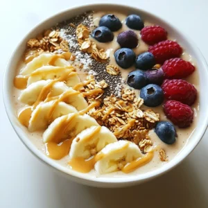 - 2 ripe bananas, frozen and sliced - 1 cup almond milk (or preferred milk) - 2 tablespoons natural peanut butter - 1 tablespoon honey or maple syrup (optional) - 1/2 teaspoon vanilla extract - Toppings: sliced banana, granola, chia seeds, shredded coconut, berries, and extra peanut butter To make the Peanut Butter Banana Smoothie Bowl, you need simple, fresh ingredients. Start with ripe bananas; they should be sweet and ready to freeze. Freezing adds a creamy texture to your smoothie. Next, choose your milk. Almond milk works well, but any milk you enjoy is fine. The milk helps blend everything together smoothly. Peanut butter is a key flavor here. I recommend using natural peanut butter without added sugar. This choice keeps the taste pure and wholesome. Honey or maple syrup is optional, but I like to add it for a touch of sweetness. You can adjust how much you use based on your taste. Lastly, we have vanilla extract. Just a little bit enhances the flavors in your bowl. When it comes to toppings, the fun really begins! Sliced fresh banana adds a nice look and taste. Granola gives a crunchy bite, while chia seeds and shredded coconut add extra texture. Berries bring freshness, and a drizzle of peanut butter on top ties it all together. Gather these ingredients, and you&rsquo;re ready to create a tasty and healthy treat! {{ingredient_image_1}} To start, gather your ingredients. You will need two frozen bananas, almond milk, peanut butter, honey, and vanilla. Place them all in a blender. Next, blend the mixture on high speed. Keep blending until it is smooth and creamy. If the mix sticks to the sides, stop and scrape them down. This helps everything blend well. Once your smoothie is ready, pour it into a bowl. It should look thick and creamy. Now, it&rsquo;s time to make it pretty! Arrange your toppings on top of the smoothie. Start with sliced bananas. Then, add some granola, chia seeds, shredded coconut, and berries. You can even drizzle more peanut butter on top for a tasty finish. While blending, remember to check the consistency. If it&rsquo;s too thick, add a splash of almond milk. Blend again until you reach your desired thickness. Scraping the sides of the blender will help mix everything evenly. This step is key for getting a smooth texture. You can change the ingredients to suit your taste. If you want a different nut butter, almond or cashew butter works well. For a vegan option, use maple syrup instead of honey. If you want less sweetness, skip the honey or use just a little. You can also try adding cocoa powder for a chocolate flavor or spinach for a green boost. To get the best blend, a high-speed blender is your best friend. It makes the smoothie creamy and smooth. If you have a regular blender, you might need to blend longer. Always scrape the sides of the blender to mix well. If the smoothie is too thick, add a little more almond milk until it reaches the right texture. Bananas are great for you! They are high in potassium and vitamins. They also give you energy without added sugar. Peanut butter is a good source of protein and healthy fats. It can help keep you full longer. Together, they make a tasty and nutritious meal or snack. Pro Tips Use Frozen Bananas: Using frozen bananas will give your smoothie bowl a thicker, creamier texture, making it more satisfying and dessert-like. Customize Your Milk: Experiment with different types of milk such as coconut milk or oat milk for varied flavors and creaminess that suit your taste preferences. Layer Your Toppings: For a beautiful presentation, layer your toppings in a visually appealing way. Start with larger pieces like banana slices and finish with delicate toppings like chia seeds. Make It Extra Creamy: For a richer taste, add an extra tablespoon of peanut butter or a scoop of yogurt to enhance the creaminess and flavor of your smoothie bowl. {{image_2}} You can mix things up with fun flavors. Try a chocolate peanut butter banana bowl. Just add a tablespoon of cocoa powder. It gives a rich taste that pairs well with the peanut butter. Another great choice is a tropical smoothie bowl. Add mango or pineapple to your blend. This makes the bowl refreshing and fruity. You can even top it with toasted coconut to give it a nice crunch. If you want to change the milk, that's easy! Almond milk works well, but you can use oat or soy milk too. Oat milk gives a creamy texture, while soy milk adds extra protein. Just pick what you like best. Adjust the amount to get the right thickness for your smoothie. You may need a little more or less, depending on your milk choice. Toppings can make your smoothie bowl fun! Use seasonal fruits like strawberries in spring or apples in fall. You can also mix it up with crunchy toppings. Try granola, chia seeds, or nuts for a nice texture. A drizzle of peanut butter on top looks great and adds flavor. The key is to have fun with your toppings and make it your own! To store any unused smoothie mixture, pour it into a sealed container. Keep it in the fridge for up to 24 hours. If you want to keep it longer, consider freezing it. For fresh toppings, store sliced bananas and berries in an airtight container in the fridge. This helps them stay fresh for a few days. Granola and dry toppings should go in a cool and dry place. You can freeze ripe bananas easily. Just peel and slice them, then place them on a baking sheet. Freeze the slices until solid, then transfer them to a freezer bag. This way, you can grab them for your next smoothie bowl. You can also prep smoothie packs. Just add sliced bananas, peanut butter, and other ingredients into bags. When you want a smoothie, blend them with your choice of milk. If you have leftover smoothie, you can enjoy it cold or warm it up. To warm it, pour it into a pot. Heat gently on low, stirring often. Do not let it boil, as this can change the texture. Once warmed, you can add fresh toppings again for that crunchy bite. Yes, you can use fresh bananas. However, frozen bananas make your smoothie bowl creamier. They also keep your bowl cold and refreshing. Using frozen fruit can help you skip ice, which may dilute flavor. If you use fresh bananas, add a bit of ice to chill the smoothie. To make your smoothie bowl vegan, swap honey for maple syrup. Almond milk is a great choice for vegan milk. You can also use oat milk or coconut milk. Both work well and add nice flavor. Always check labels for animal products in your milk. Here are some tasty and healthy toppings to try: - Sliced fresh banana - Granola for crunch - Chia seeds for omega-3s - Shredded coconut for sweetness - Berries like strawberries or blueberries for antioxidants - A drizzle of peanut butter for extra flavor Feel free to mix and match these toppings to suit your taste! This blog post covers how to make a delicious smoothie bowl. You learned about the ingredients, blending tips, and health benefits. I shared ways to customize your bowl with different flavors and toppings. My hope is that you feel inspired to try new combinations. Enjoy your smoothie bowl creations! They are tasty, fun, and great for your health. Keep experimenting and find what you love best.