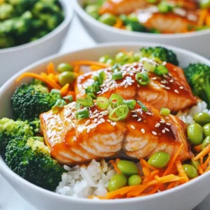 To make a Teriyaki Glazed Salmon Bowl, you need the following main ingredients: - 2 salmon fillets - 1 cup cooked jasmine rice - 1 cup steamed broccoli - 1/2 cup shredded carrots - 1/4 cup edamame (shelled) These ingredients create a tasty and balanced meal that is easy to prepare. The salmon provides healthy protein, while the rice and veggies add fiber and nutrients. The marinade is the heart of this dish. Here are the key components: - 1/4 cup soy sauce - 2 tablespoons honey - 1 tablespoon rice vinegar - 1 tablespoon sesame oil - 1 teaspoon minced ginger - 1 clove garlic, minced Whisk these together to make a delicious teriyaki glaze. It gives the salmon a sweet and savory flavor that you will love. Garnishes add a nice touch and flavor. You can use: - 2 green onions, chopped - Sesame seeds for garnish These toppings enhance the look and taste of your salmon bowl. They add freshness and crunch that make the dish even better. {{ingredient_image_1}} To make the teriyaki glaze, gather a small bowl. In this bowl, whisk together: - 1/4 cup soy sauce - 2 tablespoons honey - 1 tablespoon rice vinegar - 1 tablespoon sesame oil - 1 teaspoon minced ginger - 1 clove garlic, minced Mix these ingredients until smooth. This sauce gives the salmon its sweet and savory flavor. Next, take your two salmon fillets and place them in a shallow dish. Pour half of the teriyaki glaze over the salmon. Make sure the fish is fully coated. Let it marinate for at least 15 minutes. This step adds great flavor to the fish. Now it&rsquo;s time to bake the salmon. Preheat your oven to 400&deg;F (200&deg;C). Line a baking sheet with parchment paper. After marinating, remove the salmon from the dish and place it on the baking sheet. Pour the rest of the marinade over the salmon. Bake for 12 to 15 minutes. The salmon is done when it flakes easily with a fork. For extra caramelization, broil it for 2 to 3 minutes. While the salmon bakes, prepare your bowls. Scoop 1 cup of cooked jasmine rice into each bowl. Arrange steamed broccoli, shredded carrots, and edamame around the rice. When the salmon is ready, place a fillet on top of each rice bowl. Drizzle extra teriyaki glaze over everything if you want more flavor. Finish by garnishing with chopped green onions and a sprinkle of sesame seeds. Enjoy your colorful and tasty meal! To make salmon flaky, choose fresh fillets. Look for flesh that is bright and moist. When baking, use a hot oven set to 400&deg;F (200&deg;C). Bake for 12-15 minutes. Check if it flakes easily with a fork. If it does, it&rsquo;s ready to eat. If you want a crispy top, broil it for 2-3 minutes. This gives it a nice caramelized finish. You can boost the flavor of your teriyaki glazed salmon bowl. Add some fresh herbs like cilantro or basil for a zesty touch. A squeeze of lime juice adds brightness. You can also sprinkle crushed red pepper for heat. For a crunch, try adding chopped nuts, like cashews or peanuts. These small changes create new taste experiences. Grilling your salmon gives it a smoky flavor. Preheat your grill to medium-high heat. Oil the grates to prevent sticking. Cook the salmon for about 6-8 minutes on each side. Pan-searing is another great option. Heat some oil in a pan over medium heat. Cook skin-side down for 4-5 minutes, then flip. This method gives crispy skin and juicy meat. Both methods work well with the teriyaki glaze. Pro Tips Marinate for Maximum Flavor: Allow the salmon to marinate for at least 30 minutes if time permits, as this enhances the flavor absorption from the teriyaki glaze. Use Fresh Ingredients: Always opt for fresh ginger and garlic for the best flavor. Dried versions can alter the taste of your teriyaki glaze. Check for Doneness: Salmon is perfectly cooked when it flakes easily with a fork but still retains a moist texture. Use a fork to test doneness before removing it from the oven. Customize Your Bowl: Feel free to add other vegetables like bell peppers or snap peas to your bowl for added nutrition and color. {{image_2}} You can swap salmon for chicken or tofu. Chicken thighs or breasts work well. Cut them into pieces and use the same marinade. Cook chicken until it reaches 165&deg;F for safety. For tofu, use firm tofu. Press it to remove extra water, then cube it. Marinate like you would with salmon. Bake or pan-sear until golden. Each option brings a unique taste to your bowl. You can change the veggies based on what you have. Try snap peas, bell peppers, or zucchini. You can roast or steam them to keep them crisp. Toss in some baby spinach for a fresh touch. Each vegetable adds its own flavor and texture. This keeps your bowl exciting and colorful. Jasmine rice is light and fluffy, but you can use other types. Brown rice adds a nutty flavor and is more filling. Cauliflower rice is great for a low-carb option. Quinoa is another healthy choice, full of protein. Each rice type changes the bowl's taste and texture. Choose what you enjoy most! To keep your teriyaki glazed salmon bowl fresh, store it in an airtight container. Make sure to place the salmon and veggies separate from the rice. This helps keep the rice from getting soggy. Leftovers can last up to three days in the fridge. Before you store it, let it cool to room temperature. When you're ready to enjoy your leftovers, reheating is simple. Use the microwave for quick heat. Place the salmon and veggies on a plate. Heat for about one to two minutes. Stir the rice to help it warm evenly. You can also reheat in an oven. Preheat the oven to 350&deg;F. Cover the dish with foil and heat for about ten minutes. Freezing is a great option if you want to save time. Pack the salmon, rice, and veggies in separate freezer-safe bags. Make sure to remove as much air as possible. This helps prevent freezer burn. You can freeze for up to two months. When you're ready to eat, thaw it overnight in the fridge. Reheat as described above for the best taste. You can marinate salmon in teriyaki sauce for about 15 to 30 minutes. This time lets the fish soak up the sweet and salty flavors. If you marinate it too long, the fish can become too salty. For best results, keep it within that time frame to enjoy a tasty meal. Yes, you can make the teriyaki glaze ahead of time. Simply mix all the glaze ingredients in a bowl and store it in the fridge. It can last for up to a week. This way, you can save time when you are ready to cook. Several side dishes complement teriyaki glazed salmon bowls nicely. Here are some great options: - Steamed broccoli - Shredded carrots - Edamame - Pickled vegetables - Cucumber salad - Miso soup These sides add color and crunch to your meal. They also enhance the flavors of the salmon. Enjoy mixing and matching for a well-rounded dish! You learned how to make a tasty Teriyaki Glazed Salmon Bowl. We covered the main ingredients, marinade, and garnishes. I shared step-by-step instructions to prepare the glaze, marinate the salmon, and assemble your bowl. You also got helpful tips for making the salmon flaky and ideas for variations, like using chicken or tofu. Storing leftovers and reheating them is simple too. Now you're ready to enjoy this dish in many ways. Cooking can be fun and easy&mdash;enjoy your Teriyaki bowl!