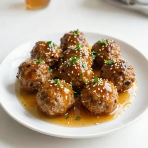 To make these honey garlic meatballs, gather the following items: - 1 lb (450g) ground beef or chicken - 1/2 cup breadcrumbs - 1/4 cup grated Parmesan cheese - 1/4 cup fresh parsley, chopped - 1 clove garlic, minced - 1 egg - Salt and pepper to taste - 1/2 cup honey - 1/4 cup soy sauce (or tamari for gluten-free) - 1 tablespoon rice vinegar - 1 teaspoon sesame oil - 1 teaspoon crushed red pepper flakes (optional) These main ingredients create a delicious flavor base. You can add some fun extras to change up the taste: - Chopped green onions for garnish - Sesame seeds for topping - Additional herbs like thyme or basil - A splash of lime juice for zest These options let you customize your meatballs to your liking. If you have dietary needs, here are some easy swaps: - Use ground turkey or pork instead of beef or chicken. - Replace breadcrumbs with crushed gluten-free crackers. - For a vegan option, try using lentils or chickpeas. - Use coconut aminos instead of soy sauce to avoid soy. These substitutions ensure everyone can enjoy this dish. {{ingredient_image_1}} First, preheat your oven to 400&deg;F (200&deg;C). This step is key for cooking the meatballs evenly. Line a baking sheet with parchment paper. This helps prevent sticking and makes cleanup easier. In a large bowl, mix the ground beef or chicken, breadcrumbs, and Parmesan cheese. Add the chopped parsley, minced garlic, egg, salt, and pepper. Use your hands to combine everything well. This helps all the flavors blend. Now, shape the mixture into small balls, about 1 inch wide. Place each meatball on the baking sheet. Bake the meatballs for 15-20 minutes. Watch for them to turn brown and cook through. While they bake, prepare the sauce. In a small saucepan, mix honey, soy sauce, rice vinegar, sesame oil, and optional red pepper flakes. Heat this mixture on medium. Stir it until it simmers. This sauce will add a sweet and savory taste to your meatballs. After baking, take the meatballs out of the oven. Place them in a big bowl and pour the honey garlic sauce over them. Gently toss to coat them well. For a nice finish, put the coated meatballs back on the baking sheet and broil for 2-3 minutes. This step caramelizes the sauce, making them extra tasty. Serve them warm, and feel free to add more parsley for garnish. Enjoy! To make soft and juicy meatballs, choose the right meat. I like using ground beef or chicken. Ground beef gives a rich flavor, while chicken keeps it lighter. Always add breadcrumbs to help bind the meat. The egg also helps keep them moist. If you want a bit of crunch, use panko breadcrumbs instead. Don't overmix the meat. Gently combine the ingredients to keep the meatballs tender. Add-ins can boost the flavor of your meatballs. Try mixing in some grated cheese, like Parmesan, for a savory taste. Fresh herbs like parsley or basil add brightness. If you want a kick, add crushed red pepper flakes. You can also include finely chopped onions or bell peppers for extra texture and sweetness. These little tweaks make a big difference in taste. You can cook your meatballs in different ways. Baking them in the oven is easy and requires less oil. Preheat your oven to 400&deg;F (200&deg;C) for a nice caramelized finish. If you prefer the skillet, heat some oil over medium heat. Cook the meatballs until they are browned on all sides. Both methods work well, so choose the one that suits you best! Pro Tips Use Fresh Ingredients: Fresh parsley and minced garlic enhance the flavor of the meatballs significantly. Always opt for fresh over dried when possible. Adjust the Heat: If you prefer a milder dish, omit the crushed red pepper flakes. For extra heat, increase the amount according to your taste. Meatball Size Matters: Try to keep meatballs uniform in size for even cooking. A 1-inch diameter is ideal for perfect bite-sized pieces. Serve with Style: For an impressive presentation, drizzle with extra honey garlic sauce and sprinkle sesame seeds and sliced green onions before serving. {{image_2}} You can easily make honey garlic meatballs gluten-free. Use tamari instead of soy sauce. Choose gluten-free breadcrumbs. These simple swaps keep the meatballs tasty without gluten. While I love using ground beef or chicken, you can try other meats. Ground turkey works well and stays juicy. For a lighter option, use ground pork. Each protein adds its own flavor. Get creative with flavors from around the world! Add ginger and scallions for an Asian twist. Or mix in cumin and coriander for a Middle Eastern vibe. You can even try adding fresh herbs like cilantro for a bright touch. Each variation gives a unique taste to your meatballs. After you make the honey garlic meatballs, you can store them in the fridge. Place them in an airtight container. They will stay fresh for about three days. If you want to keep the meatballs and sauce separate, do that. This helps them stay tasty longer. When ready to eat, just heat them up. You can freeze the meatballs too. First, let them cool completely. Then, place them on a baking sheet in a single layer. Freeze them for about one hour. Once frozen, transfer them to a freezer bag. They will last up to three months. This method keeps them fresh and ready for later. To reheat meatballs, you have a few good options. You can use the oven, microwave, or stovetop. For the oven, preheat to 350&deg;F (175&deg;C). Place the meatballs on a baking tray and heat for about 10-15 minutes. If using a microwave, heat them in short bursts. Stir in between to ensure even heating. On the stovetop, add them to a pan with a little sauce. Heat gently until warm. Enjoy your tasty meatballs anytime! You can serve honey garlic meatballs in many ways. They taste great on their own. You can also serve them over rice or noodles for a full meal. They make a perfect appetizer too. Pair them with a fresh salad to add some crunch. Add some steamed veggies for color and nutrition. You can also use them in sliders for a fun twist! Yes, you can make these meatballs ahead of time. Prepare the meatballs and bake them. Let them cool, then store them in the fridge. You can keep them for up to three days. When ready to eat, just reheat them and add the sauce. If you want, freeze them before baking. They will last for about three months in the freezer. Just thaw and bake them when you want to enjoy! To make the sauce spicier, add more crushed red pepper flakes. Start with a small amount, then taste it. You can also add hot sauce to the mix. Sriracha or chili garlic sauce works great. If you want a kick, try adding fresh minced chili peppers. Adjust the spice level to fit your taste. Enjoy your spicy honey garlic meatballs! To sum up, this blog post covers all you need for perfect honey garlic meatballs. You learned about the main and optional ingredients, as well as substitutions. Step-by-step instructions guide you through preparation, mixing, baking, and finishing touches. Tips help you master texture and flavor. Variations show how to cater to different diets and tastes. Finally, you have storage and reheating info for your meals. Enjoy making these tasty meatballs on your own!