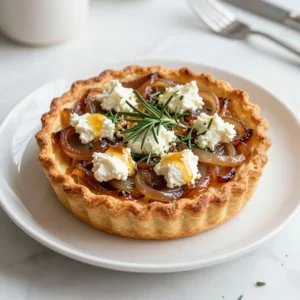 - Puff pastry, thawed - Onions, thinly sliced - Olive oil - Balsamic vinegar - Goat cheese, crumbled - Fresh rosemary, chopped - Honey - Salt and black pepper - Egg (for egg wash) To make this tart, you need a few key ingredients. First, you will use one sheet of puff pastry. This will be the base of your tart. Next, you need two large onions. Thinly slice them for the best flavor. You will also need two tablespoons of olive oil for cooking the onions. Next, balsamic vinegar adds a nice tang. You will need one tablespoon of it. For creaminess, use four ounces of crumbled goat cheese. This cheese gives the tart its special taste. Then, add one tablespoon of fresh rosemary, chopped finely. It brings a fresh aroma that pairs well with the onions. Honey is another important ingredient. You will need one tablespoon to add sweetness. Finally, season with salt and black pepper to your taste. To finish, use one beaten egg for an egg wash. This will make the edges of the tart golden and shiny. With these ingredients, you will create a delicious caramelized onion goat cheese tart that everyone will love! {{ingredient_image_1}} Start by preheating your oven to 400&deg;F (200&deg;C). This helps the puff pastry cook evenly. A hot oven makes it puff up nicely while baking. In a large skillet, heat 2 tablespoons of olive oil over medium heat. Add 2 large onions, thinly sliced, with a pinch of salt. Stir them occasionally for about 15-20 minutes. They should turn a deep golden brown. If they stick, lower the heat and add a splash of water. This keeps them from burning and helps them caramelize. Once the onions are caramelized, stir in 1 tablespoon of balsamic vinegar. Mix well and let it cook for another 2 minutes. This adds a rich depth of flavor to your onions. Roll out 1 sheet of thawed puff pastry on a lightly floured surface. This helps remove any creases. Then, transfer it to a baking sheet lined with parchment paper. Fold the edges over to create a border. This border holds in all the yummy filling. Evenly distribute the caramelized onions over the puff pastry, leaving the border clear. Next, sprinkle 4 ounces of crumbled goat cheese over the onions. Add 1 tablespoon of chopped fresh rosemary, salt, and black pepper to taste. Drizzle with 1 tablespoon of honey for a sweet touch. Brush the edges of the puff pastry with 1 beaten egg. This egg wash gives the pastry a beautiful golden color while baking. Place the tart in your preheated oven and bake for 20-25 minutes. The pastry should be golden brown and puffed up when done. Once out of the oven, let the tart cool slightly before slicing. Serve it warm or at room temperature. You can garnish with extra rosemary if you like. Enjoy! To make great caramelized onions, use a large skillet. Heat olive oil on medium heat. Add the onions with a pinch of salt. Stir them often. Cook for about 15-20 minutes. You want them to turn deep golden brown. If they stick, lower the heat. A splash of water helps loosen them up. The slow cooking brings out their natural sweetness. When picking goat cheese, choose one that crumbles well. Fresh goat cheese has a mild flavor. Aged goat cheese offers a stronger taste. Both work great in this tart. You can also try herbed goat cheese for a flavor boost. The cheese should melt nicely and blend with the onions. If you don&rsquo;t have an egg for the wash, don&rsquo;t worry! You can use milk or cream. Brush it over the pastry edges for a nice color. This helps the puff pastry bake golden brown. A little butter can also work well. These alternatives still give a lovely finish to your tart. Pro Tips Slice Onions Evenly: Ensuring uniform thickness will help the onions caramelize evenly, preventing some from burning while others remain undercooked. Use Fresh Herbs: Fresh rosemary adds a vibrant flavor; however, feel free to experiment with other herbs like thyme or oregano to suit your taste. Chill the Puff Pastry: Keeping the puff pastry cold before baking helps it puff up more beautifully, resulting in a flakier texture. Drizzle Honey at the End: For the best flavor, drizzle honey over the tart right before serving to maintain its sweetness and prevent it from burning during baking. {{image_2}} You can get creative with your tart&rsquo;s toppings. Add saut&eacute;ed mushrooms for an earthy flavor. Spinach can bring a nice green touch. Thinly sliced apples add sweetness and crunch. Try some fresh herbs, like thyme or basil, for a burst of freshness. You can even sprinkle nuts like walnuts or pecans for some texture. These extra toppings can make the tart unique and fun. If you need a gluten-free option, look for gluten-free puff pastry at the store. Brands like Schar or Whole Foods offer good choices. You can also make your own with gluten-free flour blends. Just remember, gluten-free dough may bake a little differently. Keep an eye on it while it cooks to ensure it turns golden and flaky. To make this tart vegetarian, simply skip the egg wash. Instead, brush the edges with a bit of almond milk. For a vegan version, swap goat cheese for vegan cream cheese or a cashew cheese spread. You can create a rich flavor by mixing in nutritional yeast. This twist keeps the taste delicious and plant-based. Enjoy your cooking journey! To store your leftover tart, let it cool first. Wrap it tightly in plastic wrap or foil. Place it in the fridge for up to three days. This keeps it fresh and tasty. If you plan to eat it soon, this method works great. To reheat the tart, preheat your oven to 350&deg;F (175&deg;C). Place the tart on a baking sheet. Heat for about 10-15 minutes, or until warm. This keeps the crust crispy and the cheese soft. Avoid using the microwave, as it can make the pastry soggy. You can freeze the tart for later enjoyment. Cool it completely, then wrap it tightly in plastic wrap. Next, place it in a freezer-safe bag or container. It can stay in the freezer for up to two months. When you're ready to eat, thaw it in the fridge overnight. Reheat as described above. This way, you get to enjoy the delightful flavors anytime you want. Yes, you can use other cheeses. Feta or cream cheese work well. They give a different taste but still taste great. If you like a sharper flavor, try aged cheddar. The tart lasts about 3 days in the fridge. Store it in an airtight container. This keeps it fresh and tasty. Yes, you can make it ahead. Prepare the tart and store it before baking. Just cover it with plastic wrap. When you're ready, bake it fresh. This tart pairs well with salads or roasted veggies. A simple green salad adds freshness. Serve it with a glass of white wine for a nice touch. Yes, you can use a pie crust instead. A homemade or store-bought crust will work. You can also try phyllo dough for a lighter version. Just adjust the baking time as needed. This blog post covered how to make a delicious caramelized onion goat cheese tart. We discussed the key ingredients, step-by-step instructions, and handy tips. You learned about ways to vary the recipe and how to store your leftovers. Overall, this dish is easy and fun to make. With these steps, you'll impress anyone at your next gathering. Enjoy creating and sharing this tasty tart!