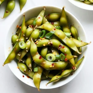 - 2 cups shelled edamame (fresh or frozen) - 3 tablespoons olive oil - 4 cloves garlic, minced - 1 tablespoon red pepper flakes (adjust to taste) - 2 tablespoons soy sauce - 1 tablespoon sesame oil - 1 tablespoon lemon juice - Salt to taste - 2 green onions, sliced (for garnish) - Sesame seeds (for garnish) To make spicy garlic edamame, you need fresh or frozen edamame. Use good olive oil for flavor. Garlic is key, so don&rsquo;t skip it! The red pepper flakes give the heat, so adjust based on your taste. Soy sauce adds saltiness, while sesame oil gives a nice nutty touch. Lemon juice brightens the dish. Finally, green onions and sesame seeds make it pretty. - Chili oil for extra spice - Fresh herbs like cilantro or basil - Cooked shrimp for added protein - Bell peppers for crunch You can add chili oil for more heat. Fresh herbs add a nice touch. Try cooked shrimp if you want protein. Bell peppers bring extra crunch and color, too! - Use avocado oil instead of olive oil - Coconut aminos can replace soy sauce for a gluten-free option - Lime juice can replace lemon juice for a twist - Fresh garlic can be swapped with garlic powder If you&rsquo;re out of olive oil, avocado oil works well. Coconut aminos are great for gluten-free folks. Lime juice brings a fun flavor change. If you don&rsquo;t have fresh garlic, garlic powder will do in a pinch. {{ingredient_image_1}} To start, you need to prepare the edamame. If you have frozen edamame, cook it according to the package instructions. This usually takes about 4 to 5 minutes in boiling water. Once cooked, drain the edamame and set it aside. Fresh edamame is also great. Just remove the pods and get ready to cook. Next, grab a large skillet or wok. Heat 3 tablespoons of olive oil over medium heat. Once hot, add 4 minced garlic cloves. Saut&eacute; them for about 1 minute. The garlic should smell great, but don&rsquo;t let it burn! After that, stir in 1 tablespoon of red pepper flakes. Keep saut&eacute;ing for another 30 seconds. Now, add your cooked edamame to the skillet. Pour in 2 tablespoons of soy sauce and 1 tablespoon of sesame oil. Toss everything together well, making sure the edamame is coated in the spicy garlic mix. Finally, drizzle 1 tablespoon of lemon juice over it all and stir again. Season with salt to taste. When mixing, be gentle. You want to keep the edamame intact. Once everything is well combined, it&rsquo;s time to serve. Transfer the edamame to a vibrant bowl. Garnish with sliced green onions and a sprinkle of sesame seeds. For added fun, serve with toothpicks. You can also add a side of chili oil for an extra kick. Enjoy your spicy garlic edamame as a tasty snack or appetizer! To saut&eacute; garlic well, start with a hot pan. Heat your olive oil over medium heat. Once the oil shimmers, add the minced garlic. Cook it for about one minute. Watch closely to avoid burning it. Burnt garlic tastes bitter and ruins the dish. Stir often to keep the garlic moving. This keeps it golden and fragrant. Spice levels matter in this recipe. If you love heat, add more red pepper flakes. Start with one tablespoon and taste as you go. You can always add, but you can't take it away. If you want less spice, reduce the flakes. You can also skip them for a milder version. Remember, the goal is to match your taste! Serving your spicy garlic edamame is all about fun! Use a bright bowl for a pop of color. Add toothpicks for easy snacking. This dish pairs well with drinks like beer or sake. You can also serve it with chili oil for extra heat. Try it alongside sushi or rice dishes for a complete meal. Enjoy the bold flavors and let your taste buds dance! Pro Tips Adjust Spice Level: Modify the amount of red pepper flakes according to your heat preference. Start with less if you are unsure. Fresh Garlic Over Powder: Always use fresh minced garlic for the best flavor; garlic powder won't provide the same aromatic quality. Garnish for Color: Add colorful garnishes like red chili slices or cilantro to enhance the visual appeal of your dish. Serving Suggestion: Pair your spicy garlic edamame with a light beer or a refreshing iced tea to balance the heat. {{image_2}} You can easily make this dish vegan and gluten-free. The key is to use gluten-free soy sauce. Look for tamari or a similar alternative. This small swap keeps the flavors intact. The rest of the ingredients are naturally vegan. Enjoy this dish without worry! Want to boost the nutrition? You can add proteins or other veggies. Cooked shrimp, chicken, or tofu work well. Add them to the skillet before the edamame. This change makes it a full meal. You might also add bell peppers or broccoli for extra crunch and flavor. Just saut&eacute; these with the garlic. There are many ways to spice up your edamame. Try adding a splash of lime juice for a zesty kick. You can also use different spices. Smoked paprika or a dash of curry powder can give a unique taste. Experiment with your favorite sauces too. Sriracha or a sweet chili sauce can add a fun twist. Each option creates a new flavor profile just for you! To store leftover spicy garlic edamame, let it cool first. Place it in an airtight container. Make sure to keep it in the fridge. This keeps the edamame fresh and tasty. You can also use a zip-top bag if you prefer. Just squeeze out the air before sealing. When you're ready to enjoy your leftovers, you can reheat them. The microwave works great for this. Place the edamame in a bowl and cover it. Heat on high for about 1-2 minutes. Stir midway to ensure even heating. You can also use a skillet. Heat on low and stir until warm. Add a splash of water for moisture if needed. Prepared spicy garlic edamame lasts about 3-5 days in the fridge. If you want to keep it longer, consider freezing it. Just store it in a freezer-safe container. Properly stored, it can last up to 3 months. When you're ready to eat it, thaw in the fridge overnight and reheat as mentioned above. Enjoy your snack any time! Cooking edamame takes about 4 to 5 minutes if frozen. For fresh edamame, it may take a bit less time. You want them bright green and tender. After cooking, drain them well to remove excess water. This keeps the flavors from getting diluted. Yes, frozen edamame works great for this recipe! It saves time and effort. Just follow the package instructions to cook them first. After that, you can easily add them to the spicy garlic mix. This makes it a quick and tasty snack. Edamame is a healthy snack packed with protein and fiber. It also contains vitamins and minerals. Some benefits include: - High in protein: Great for muscle health. - Rich in fiber: Aids digestion and keeps you full. - Low in calories: A smart choice for snacking. - Contains antioxidants: Helps fight free radicals in the body. Adding edamame to your diet can boost your overall health. Plus, it tastes fantastic in many dishes! This article covered the essentials for cooking edamame. You learned about key ingredients, cooking methods, and tips for flavor. We explored tasty variations, how to store leftovers, and answered common questions. Now, you can confidently prepare edamame in your kitchen. Experiment with flavors and enjoy this healthy snack. With these tips, edamame can fit any meal. Start enjoying fresh, delicious edamame today!